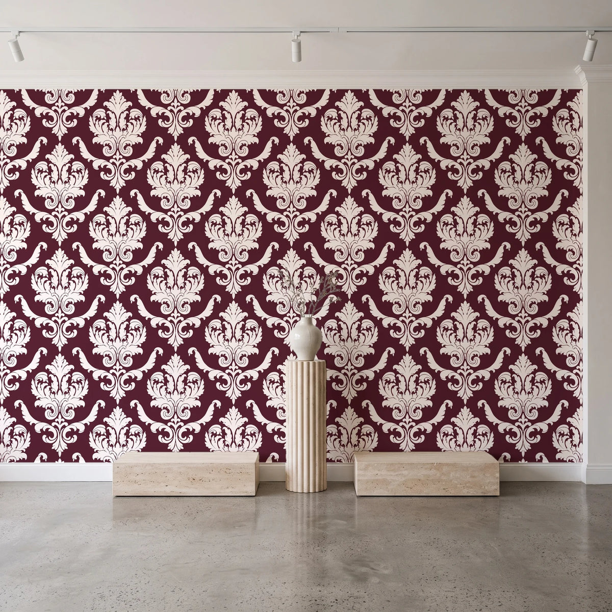 Woodland Blossom Veil Oxblood damask wallpaper behind a travertine pedestal and vase in a minimal boutique