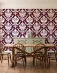Woodland Blossom Veil Oxblood damask wallpaper in a farmhouse dining room with a sage sideboard and rustic trestle table