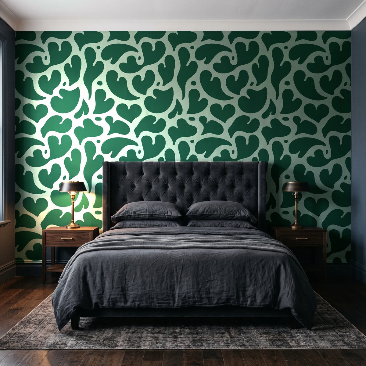 Woven Whisper Emerald abstract heart wallpaper behind a tufted headboard in a dark, moody bedroom